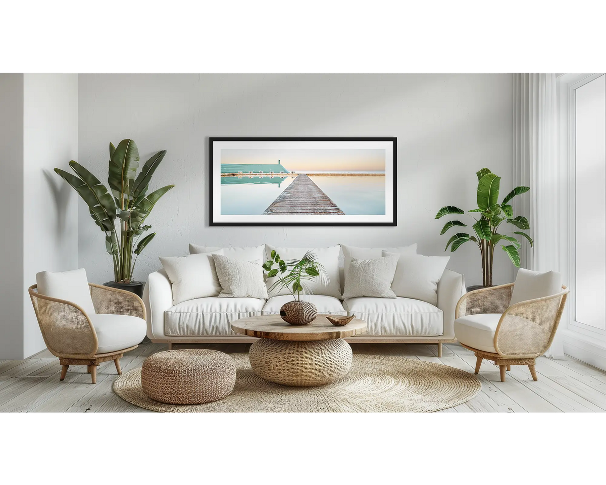 Evening Swim. Newcastle coastal wall art in a black frame, in a lounge room.