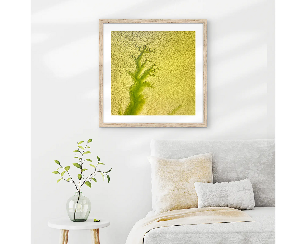 Extend. Aerial abstract, framed wall art print with a timber frame, hung on a bedroom wall.