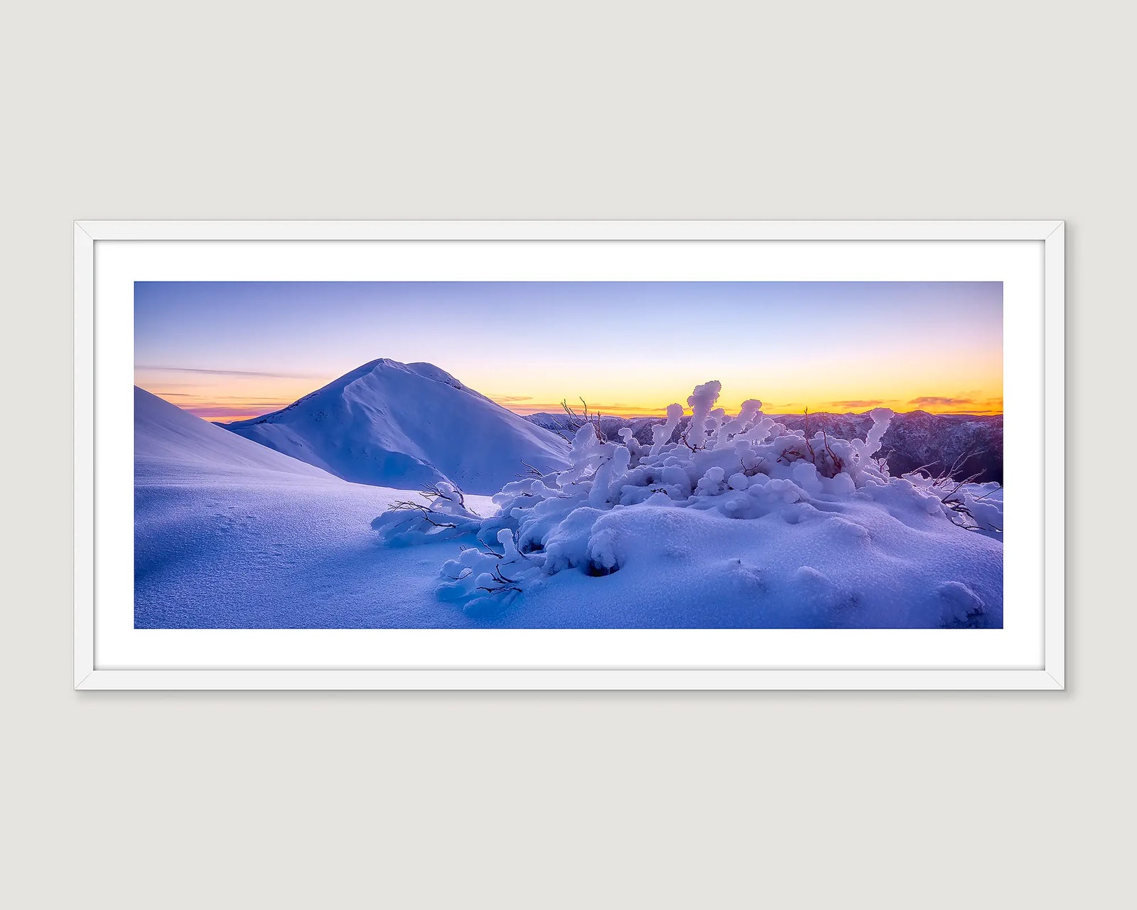 Framed photographic wall art print of a sunrise and the snowy mountain peak of Mount Feathertop and snow gums. 