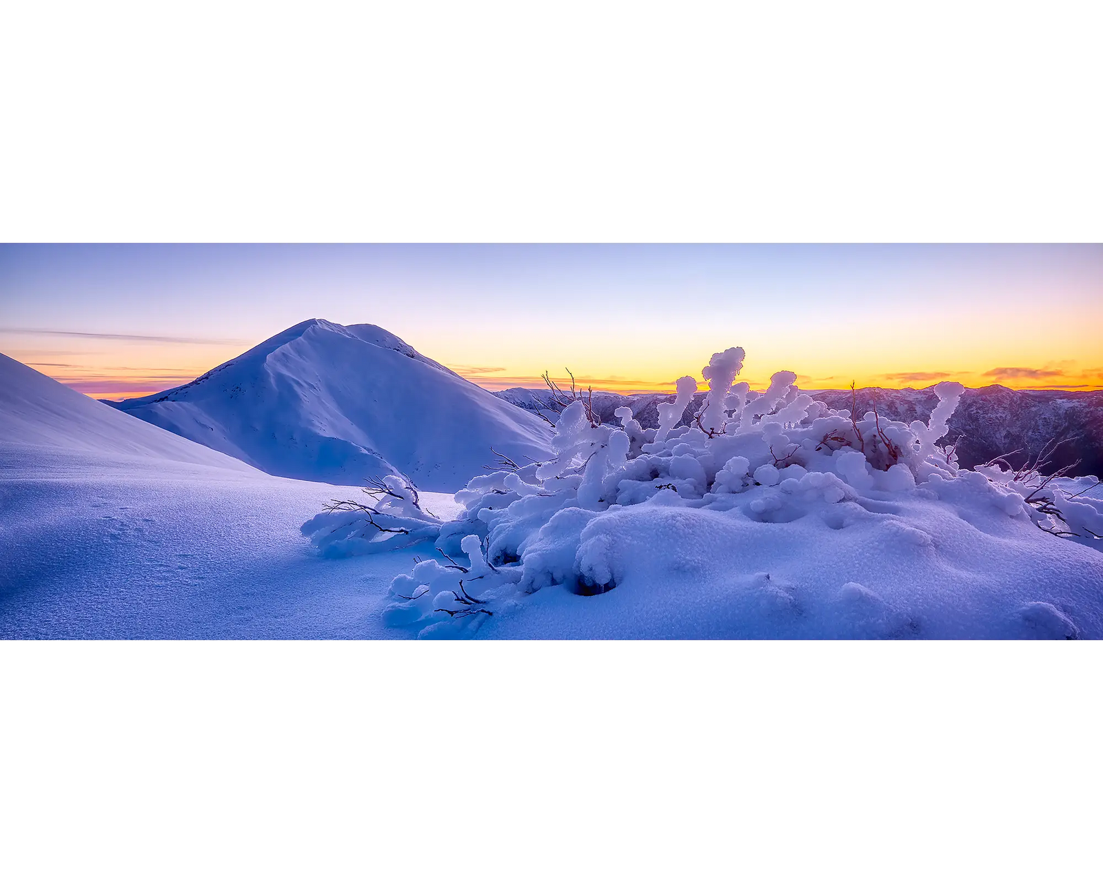 Sunrise behind Mount Feathertop with winter snow, Alpine National Park, Victoria. 