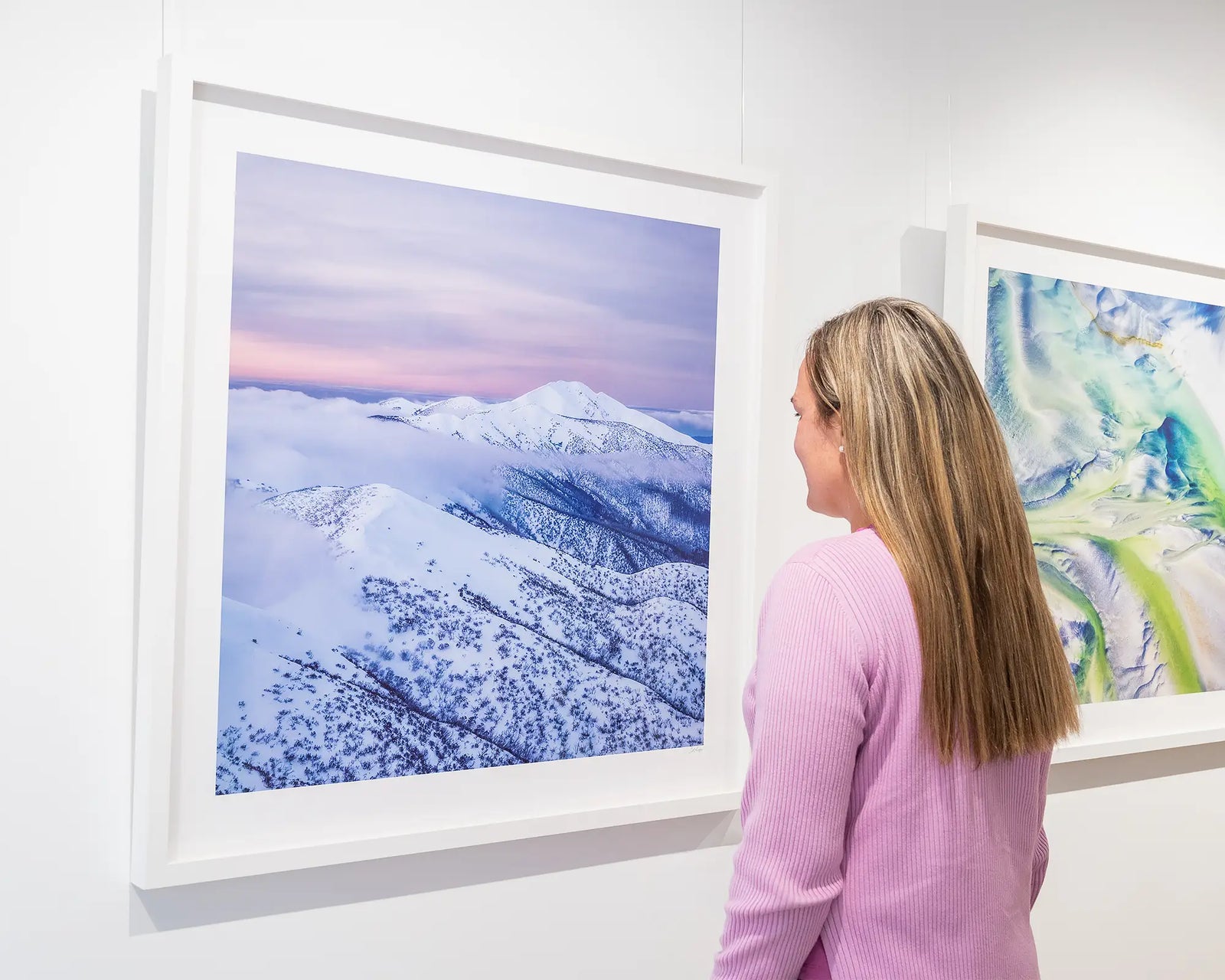 Framed photographic wall art print of fog at sunset, swirling around Mount Feathertop, covered in snow. 