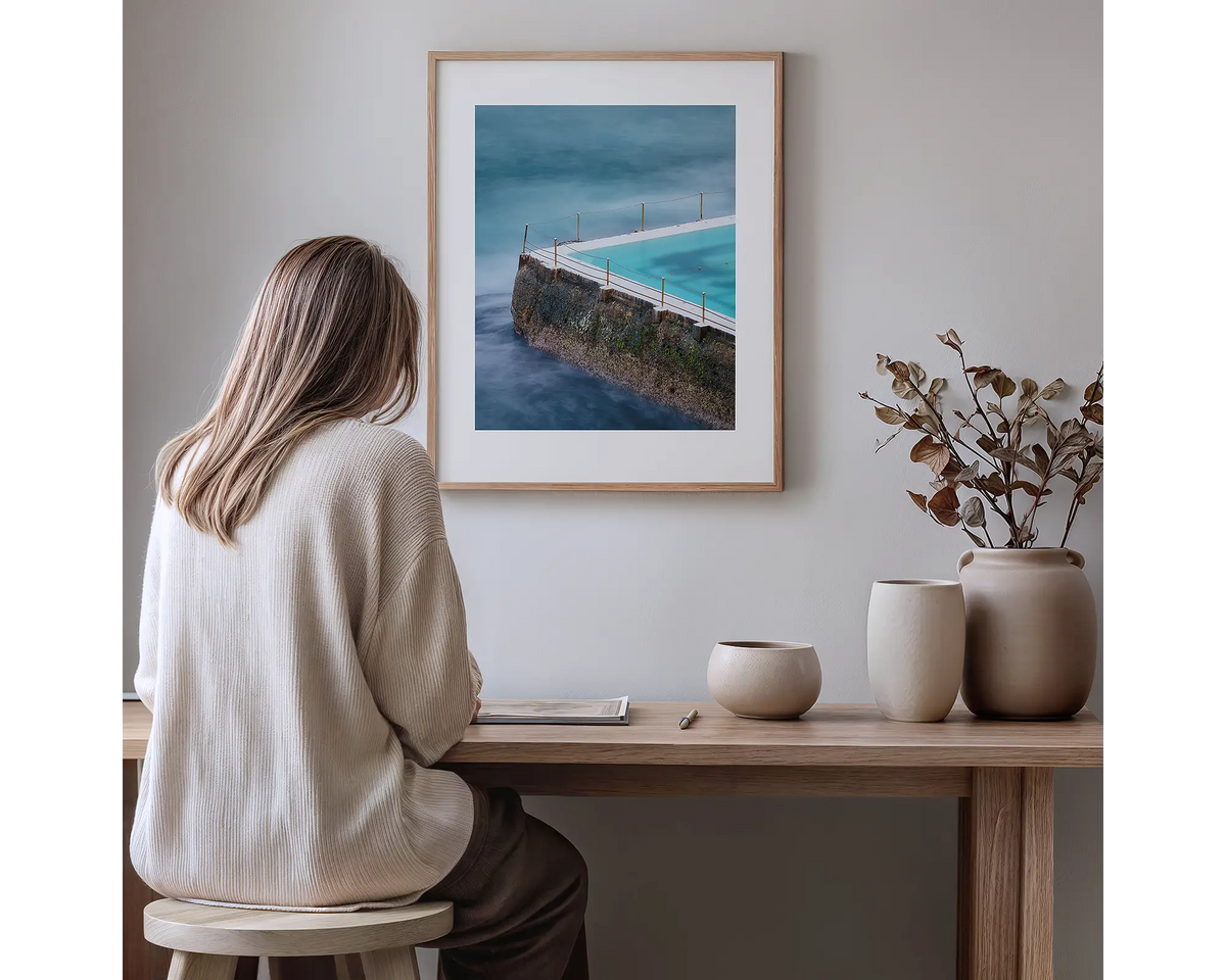 Fenced In. Bondi Icebergs photography  artwork, with a timber frame, hung in a study nook. 