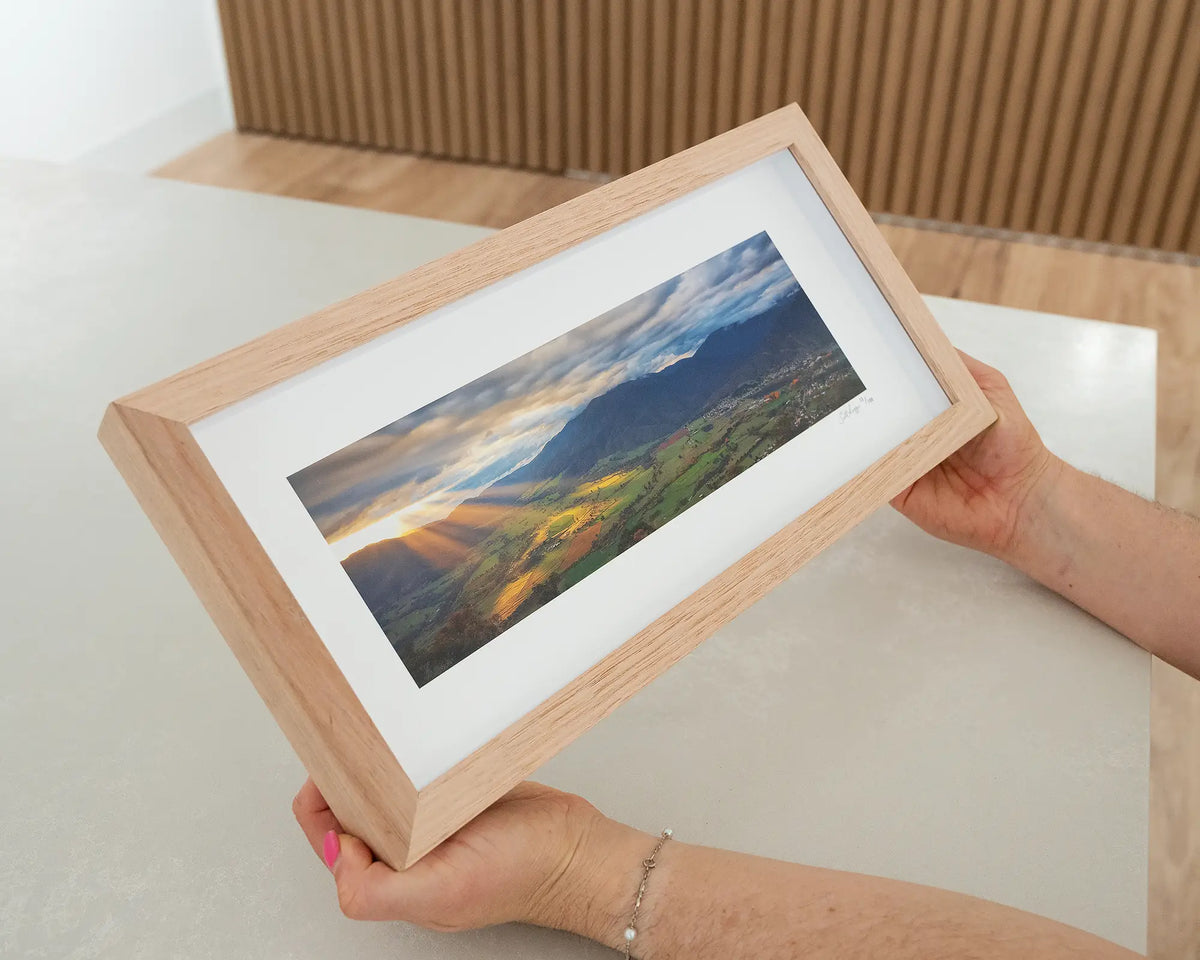 Fingers of Light. Sun rays over Mount Beauty Victoria, with timber frame being hand held.