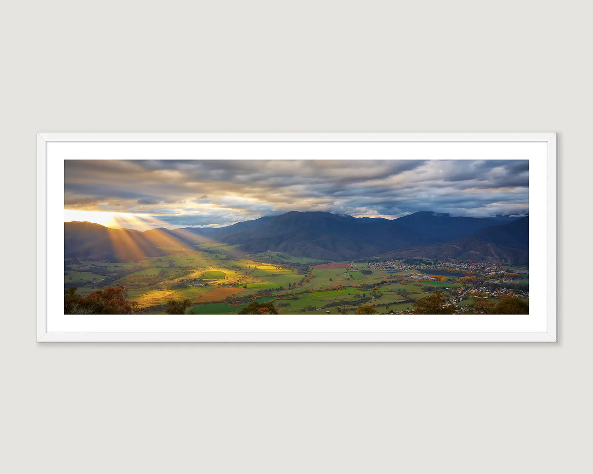 Framed wall art print of sun rays shining light over the Kiewa Valley at sunrise. 