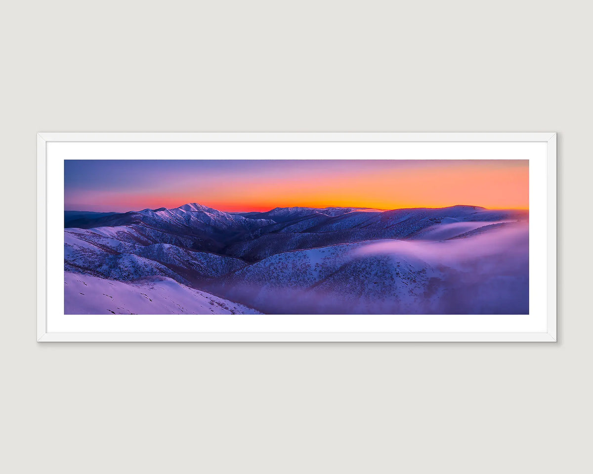 Framed photograph of snow fields covered in snow and a golden sunrise.