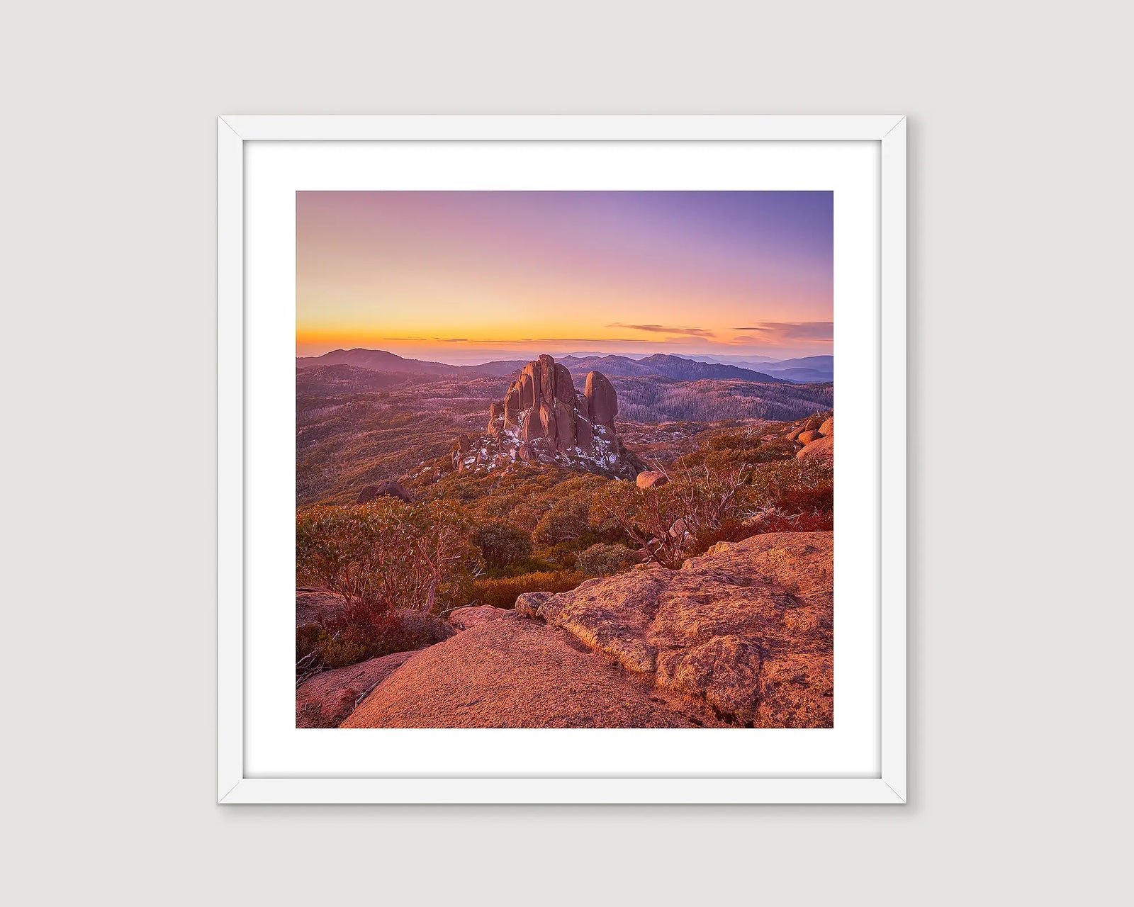 Framed wall art print of a sunset behind the Cathedral on Mount Buffalo, with a light dusting of snow. 
