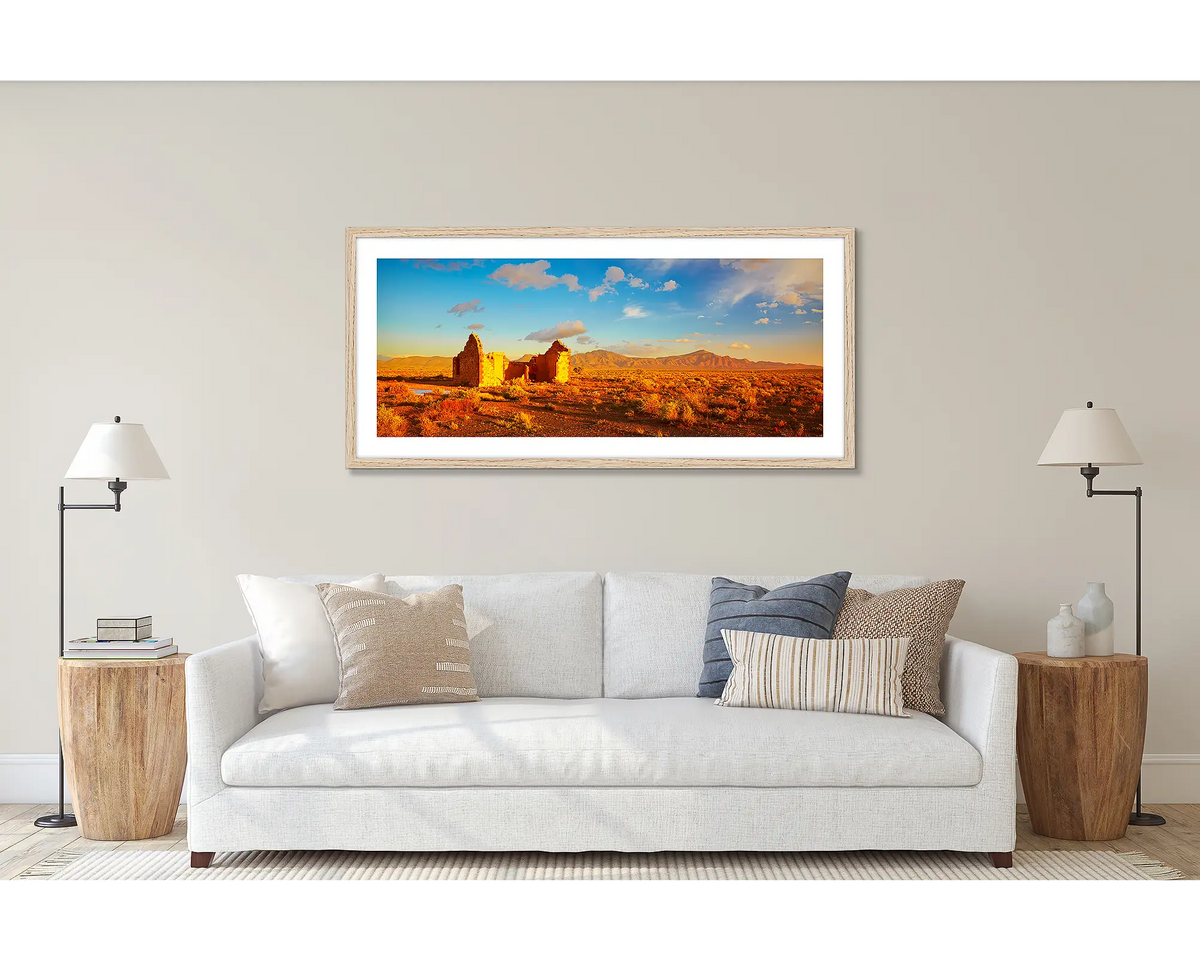 Flinders Ruins. Wall art print of a sunset in the Flinders Ranges, framed with a Tasmanian Oak frame and hung above a couch. 