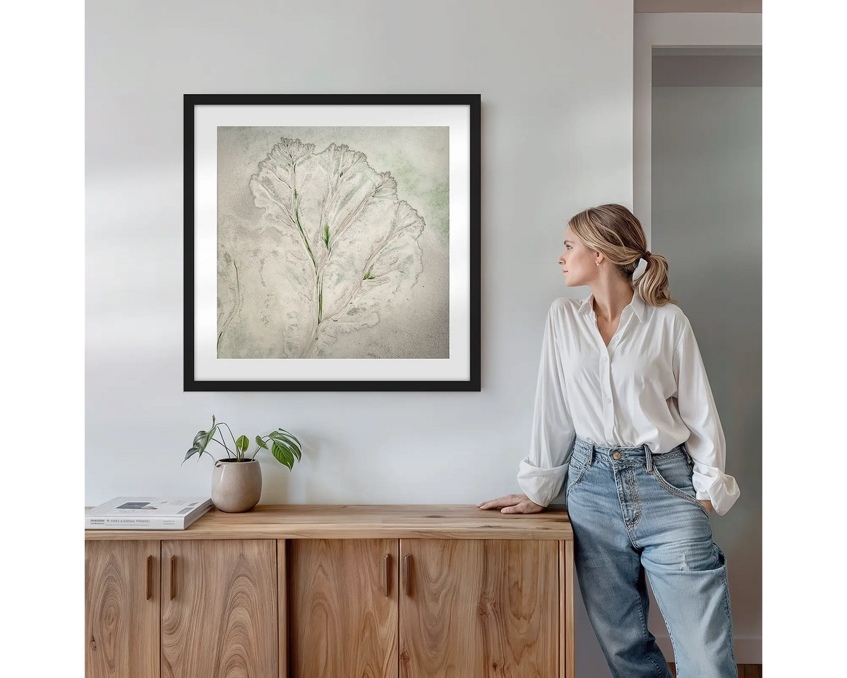 Flourish. Wall art print with black frame featuring an abstract aerial scene from the Kimberley, hung above a side table.