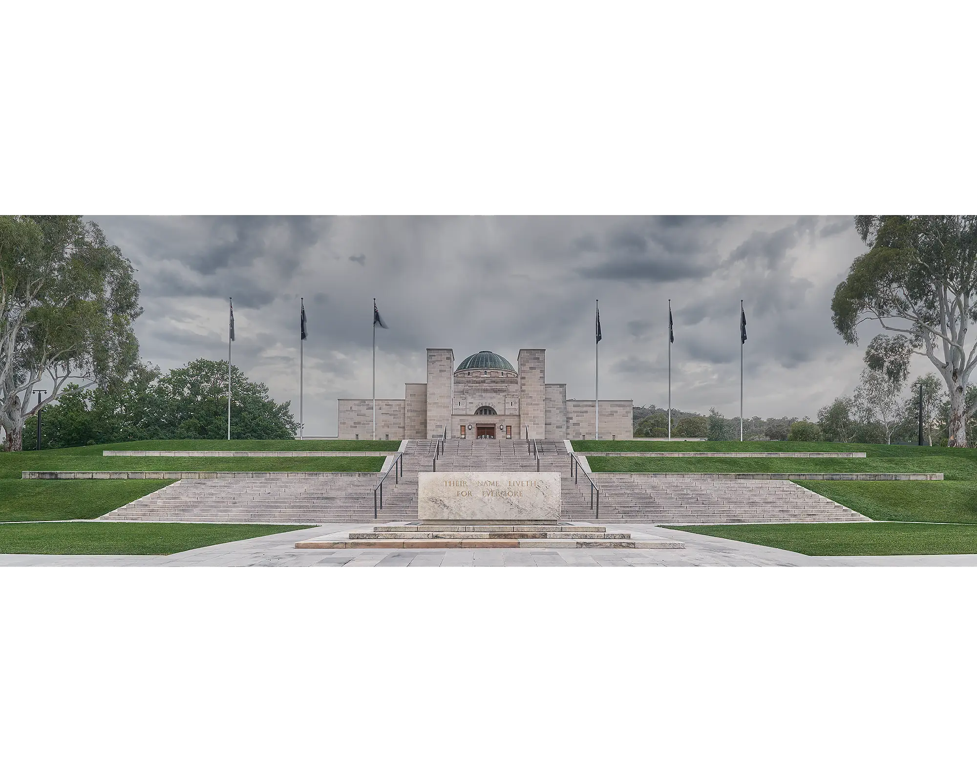 The Australian War Memorial under stormy skies with gum trees in view, Canberra. 