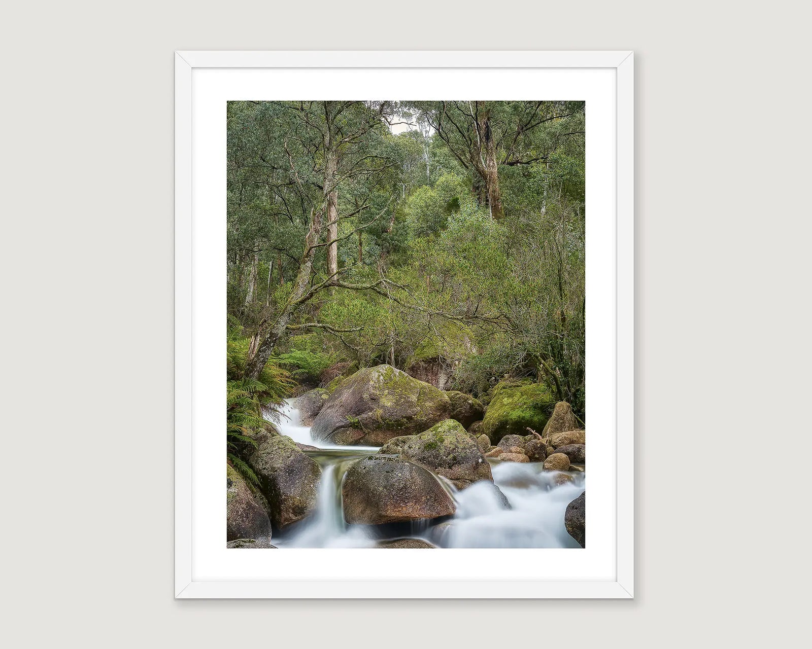 Framed wall art print of water cascading over mossy rocks amidst bushland on Mount Buffalo.