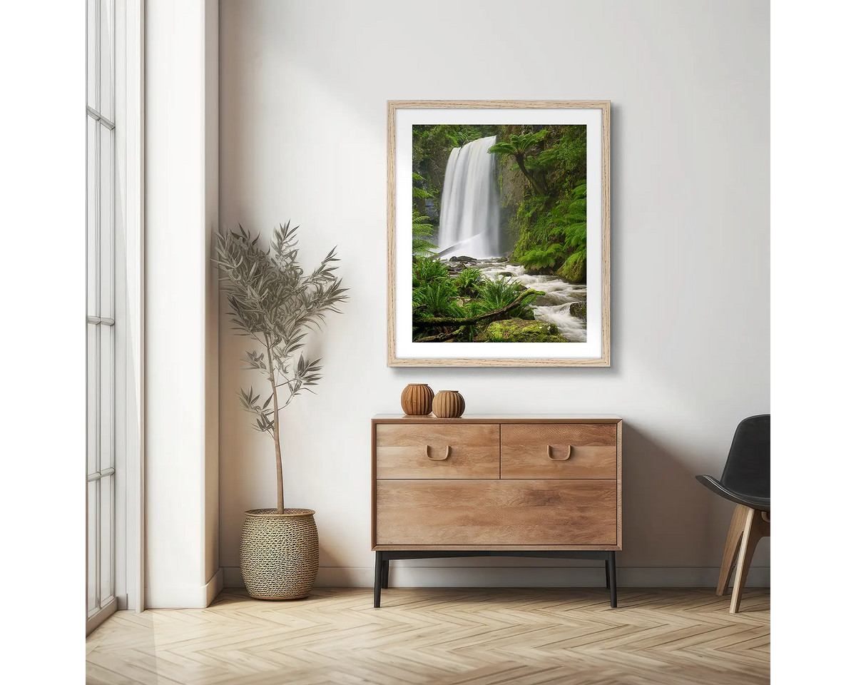 Forest Veil. Wall art print of Hopetoun Falls, framed with a timber frame and hung on an apartment wall above a side table. 