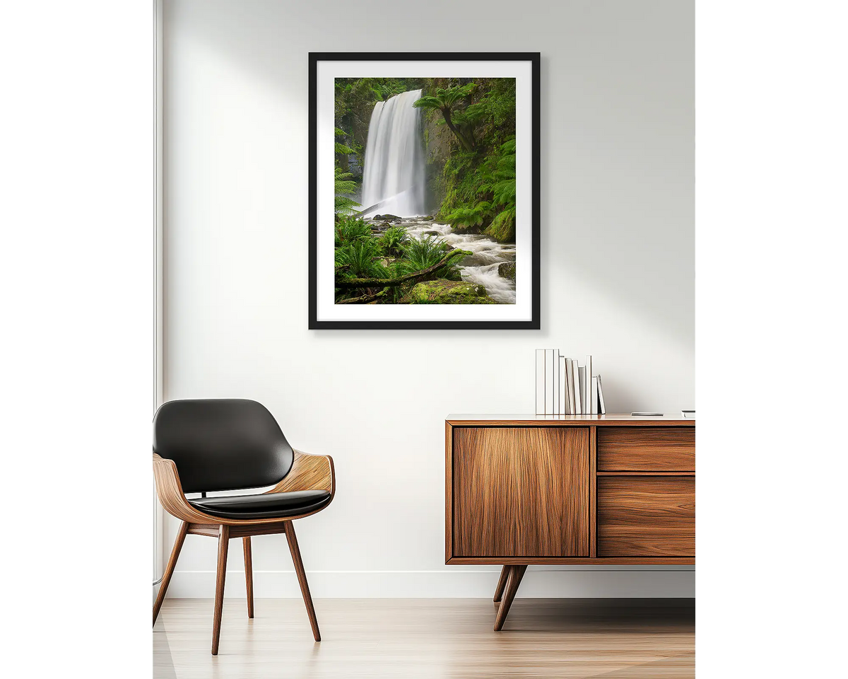 Forest Veil. Wall art print of Hopetoun Falls, with a black frame, hung in an apartment. 
