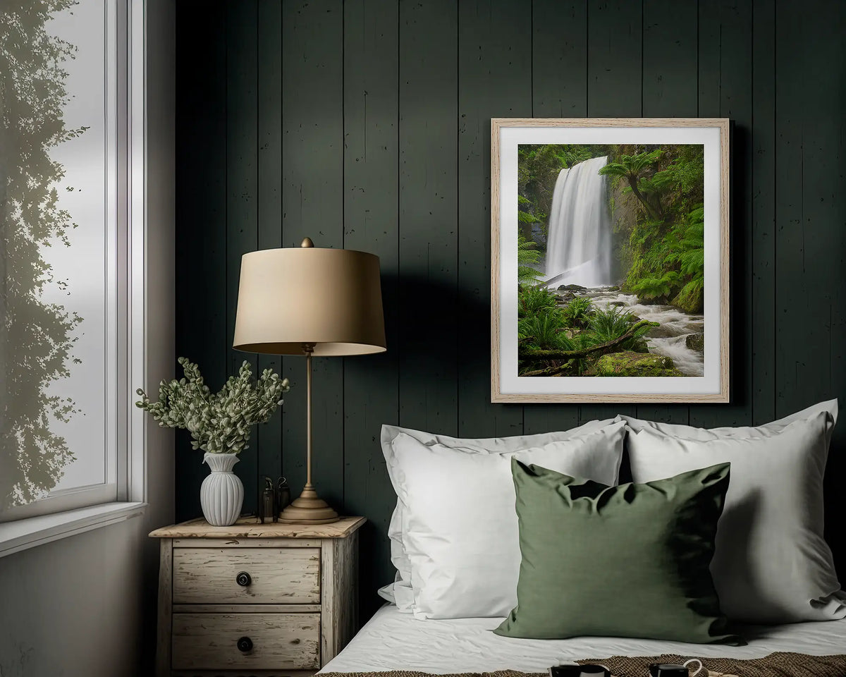 Forest Veil. Wall art print of Hopetoun Falls, with a timber frame, hung above a bed. 