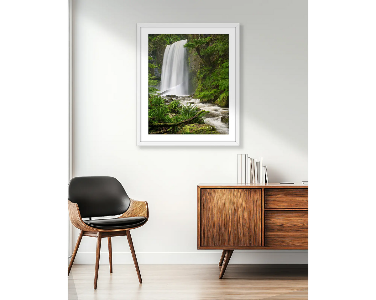 Forest Veil. Wall art print of Hopetoun Falls, with a white frame, hung in an apartment. 