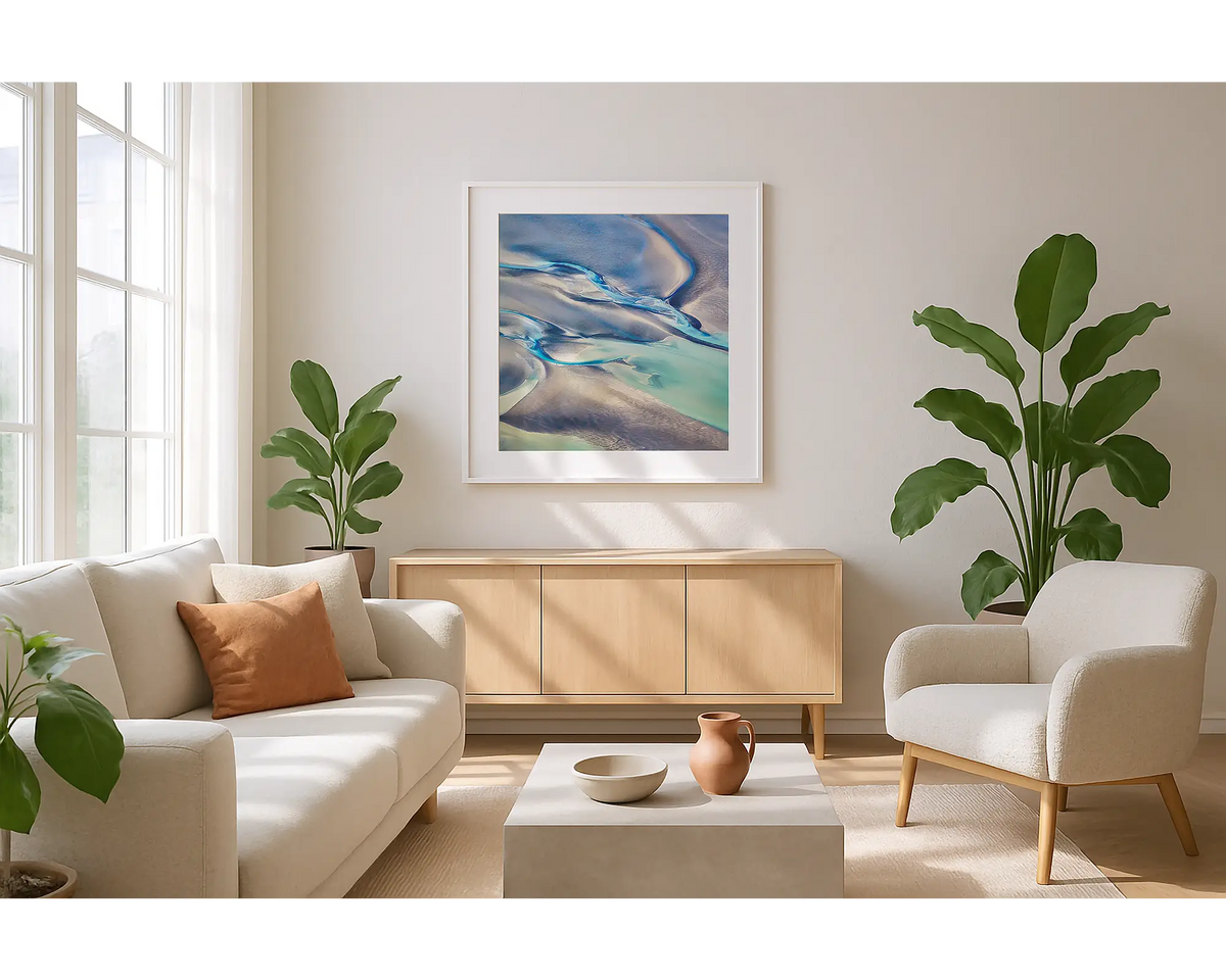 Formula. Wall art print of abstract tidal patterns, Broome, with a white frame, hung in a sunlit lounge. 
