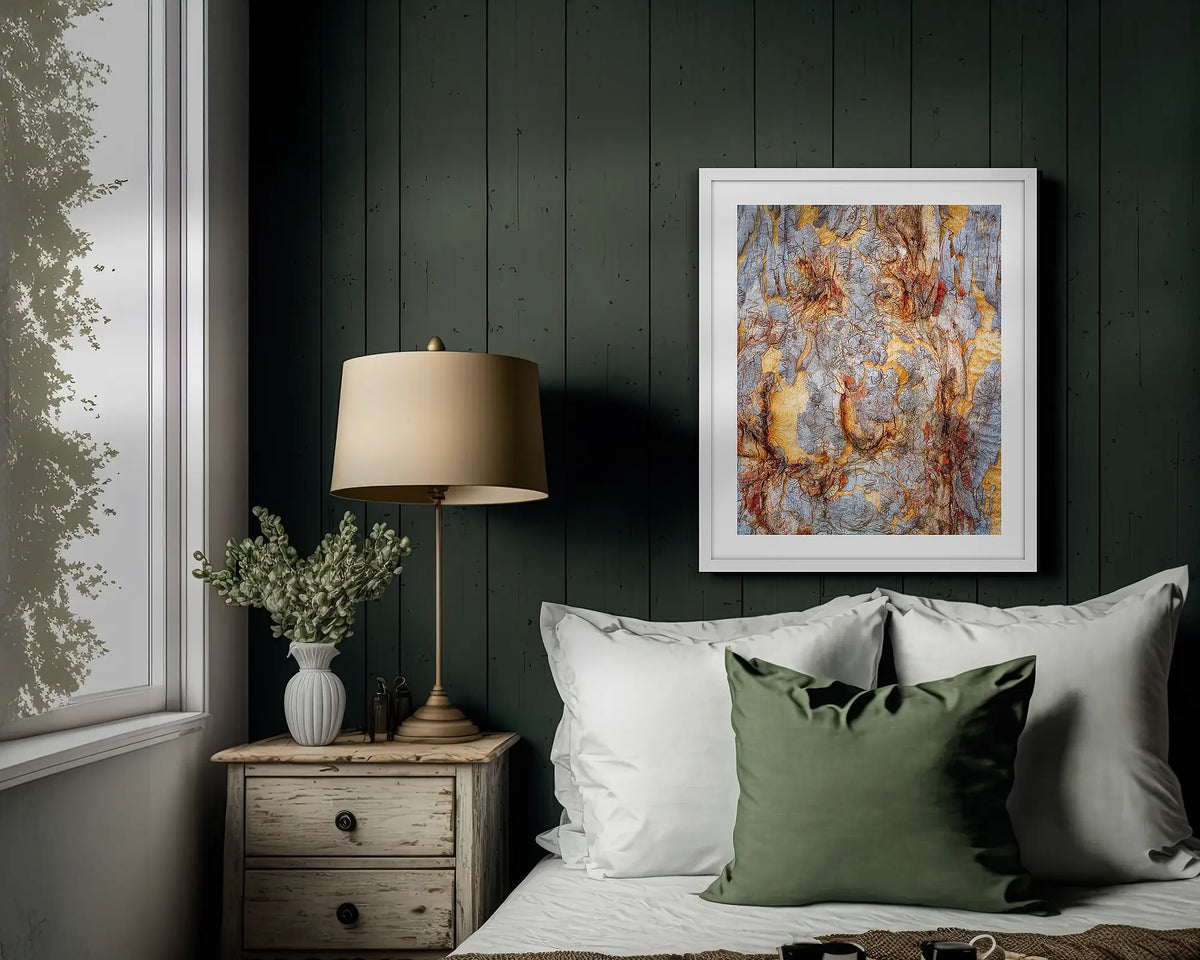 Funny Faces. Abstract wall art print of gum tree bark on Mount Ainslie, with a white frame hung above a bed. 