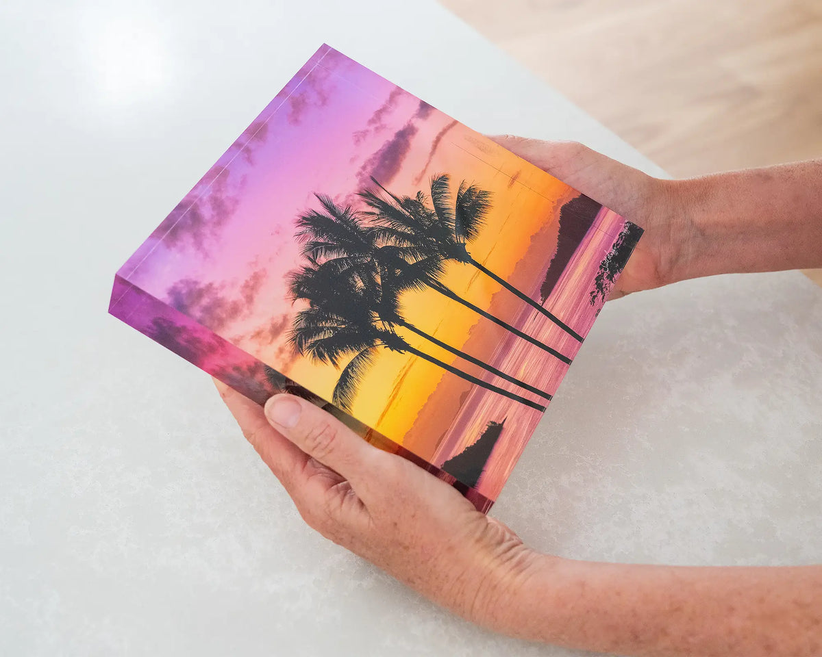 Getaway. 19cm acrylic block of palm trees at sunset, Hamilton Island Queensland, held in hands.