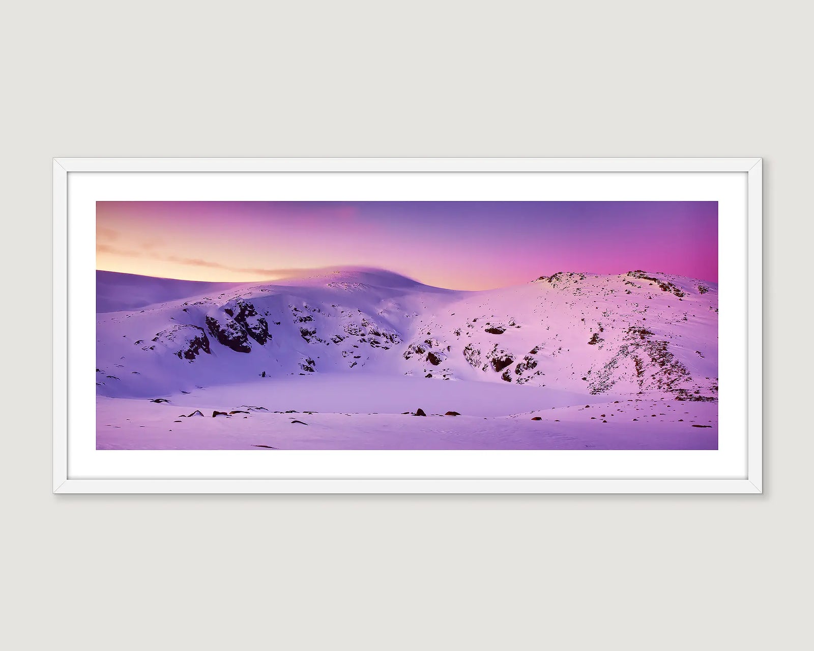 Framed wall art print of Blue Lake frozen over and a sunrise reflecting in the snow  covered mountain. 