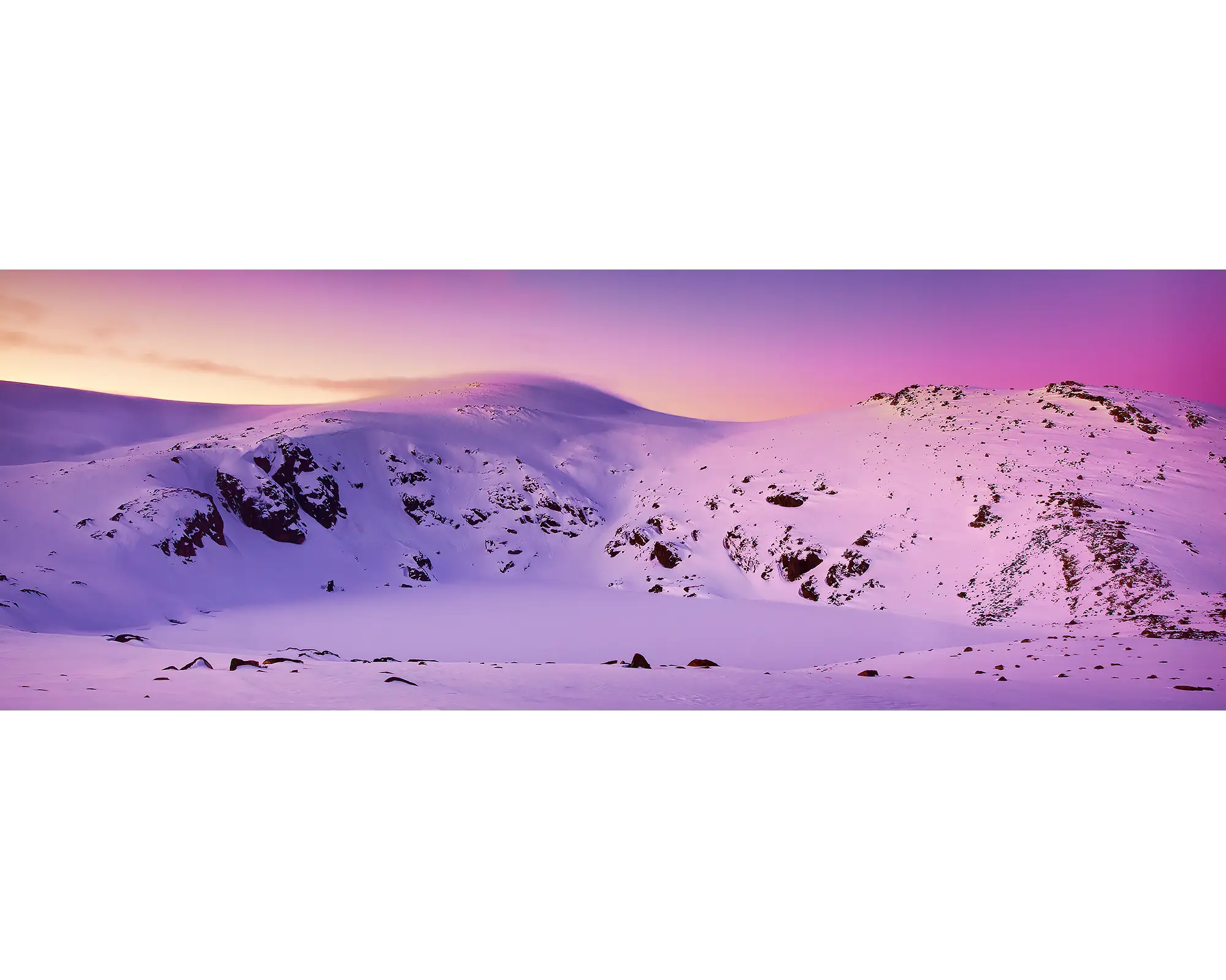 Sunset over Blue Lake frozen over and covered in snow, Kosciuszko National Park, NSW. 