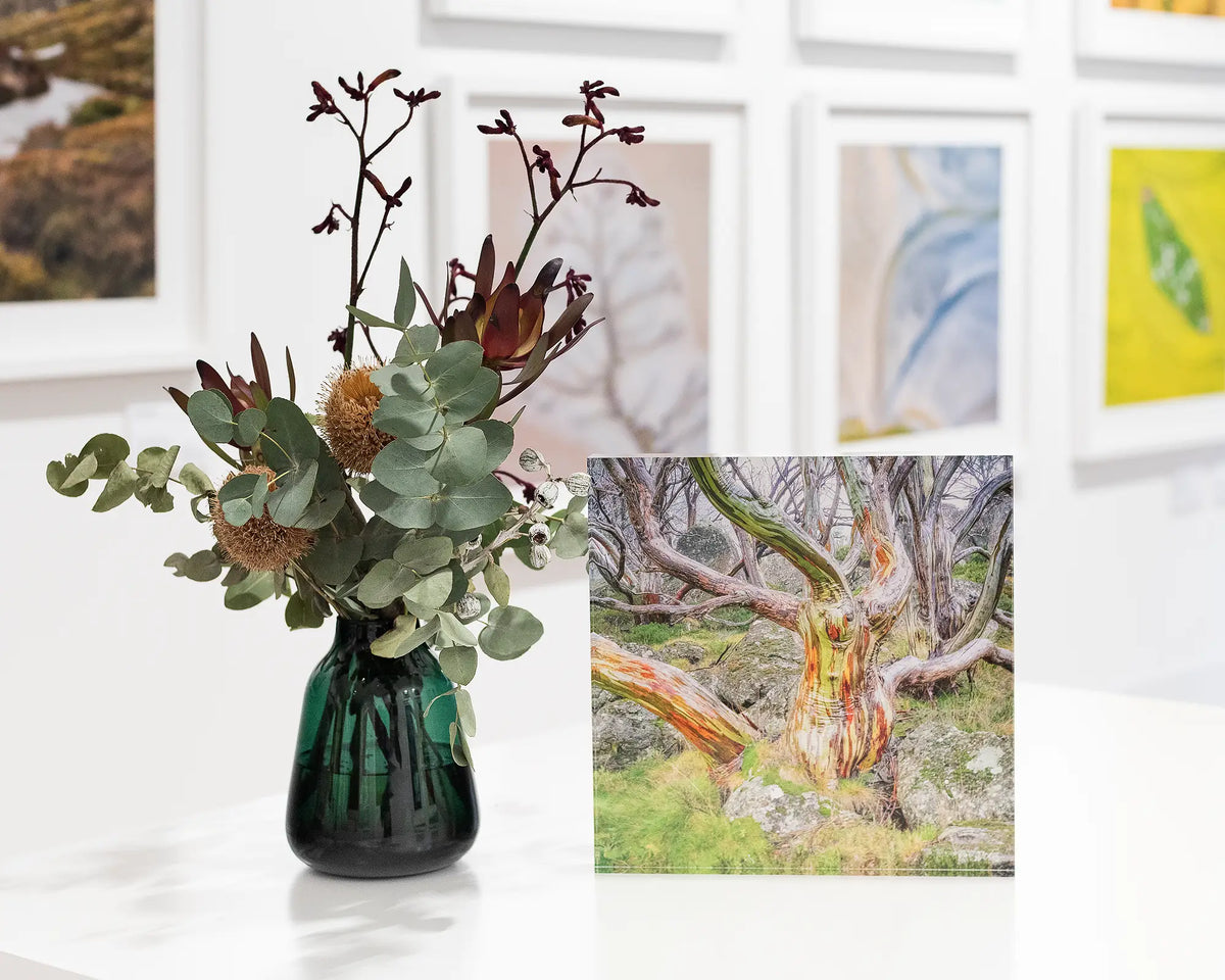 19cm x 19cm Gnarled acrylic block displayed next to a vase of flowers. 