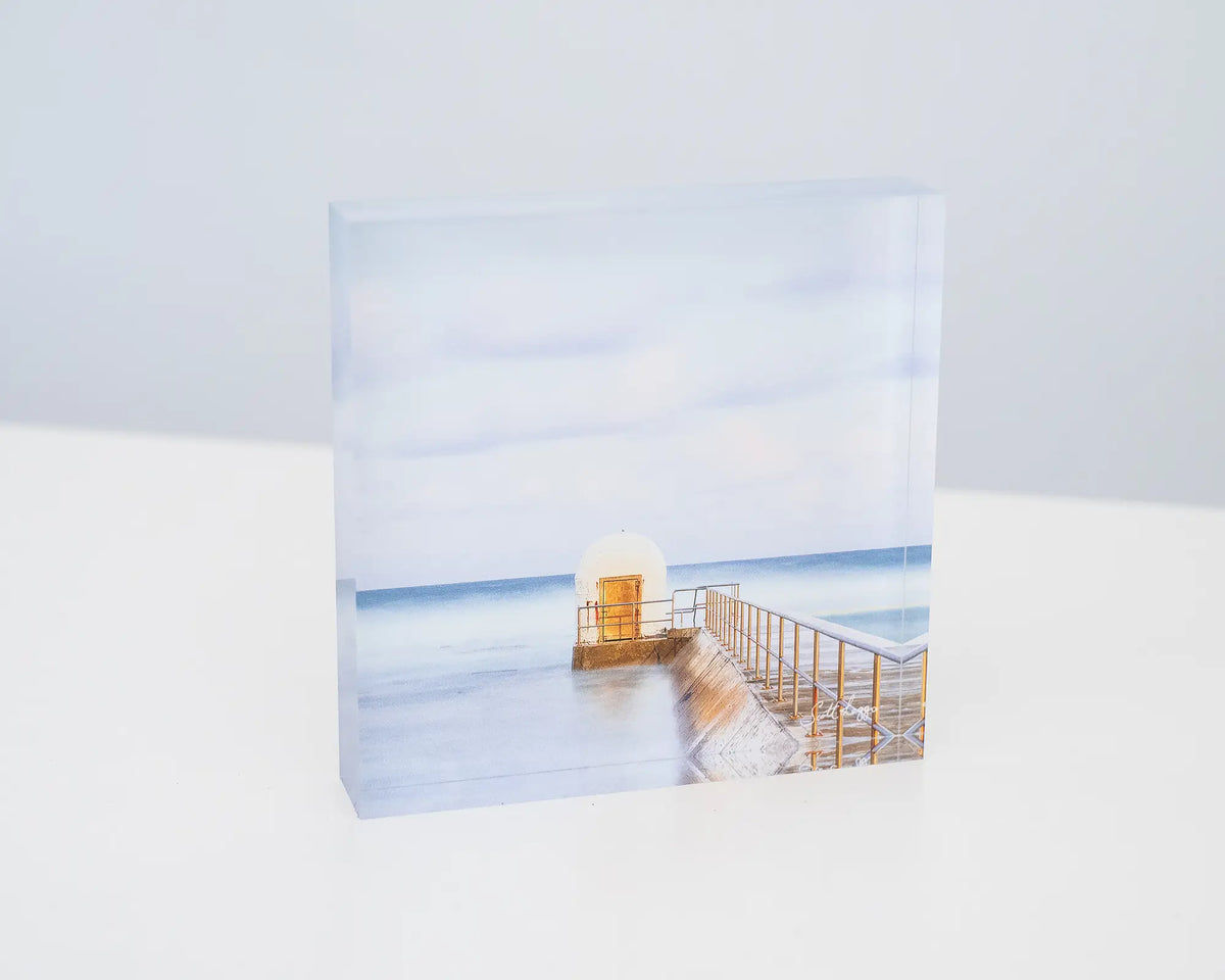 Golden Door. Acrylic block of dusk at Merewether Baths Newcastle, sitting on a desk.