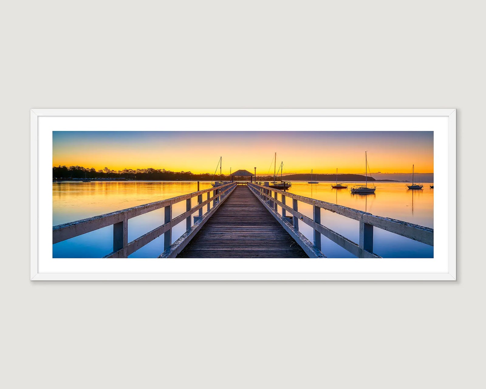 Framed photograph of a wooden pier extending into the Clyde River at sunrise.