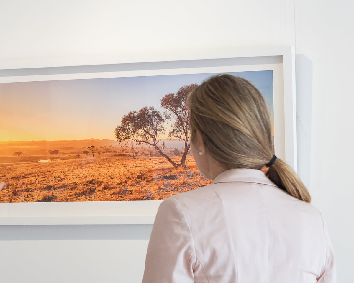 Googong Awakes. Winter sunrise at Googong, New South Wales, in gallery with person admiring.