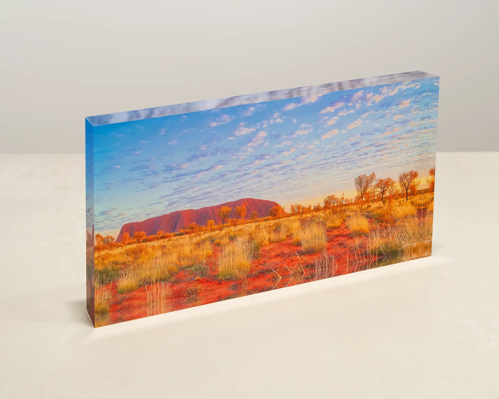 Great Southern Land. Acrylic block of Uluru sitting on a desk.