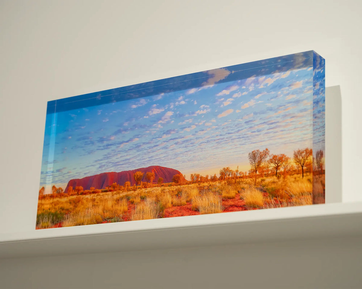 Great Southern Land. Acrylic block of Uluru sitting on a shelf.