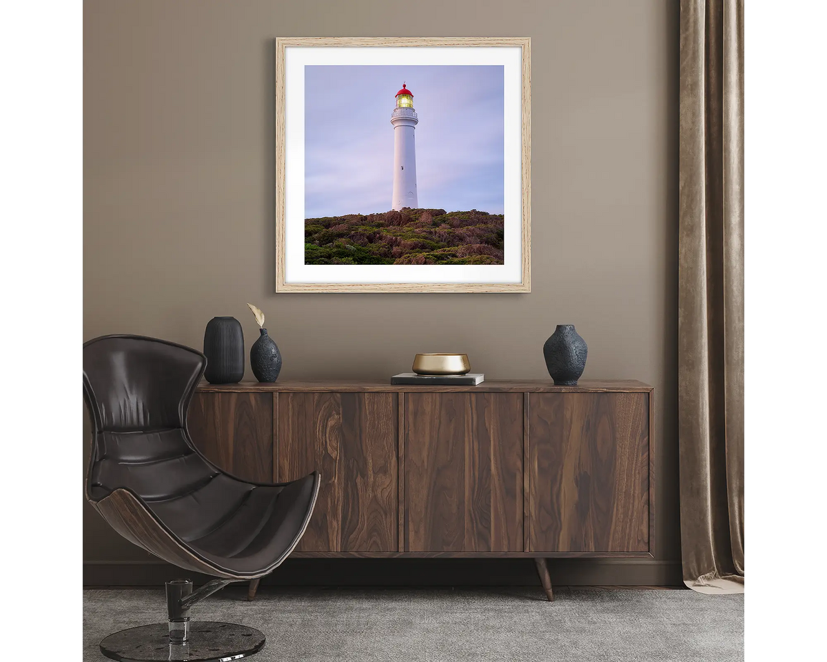Guiding Light. Wall art print of Split Point Lighthouse, framed with a timber frame and hung in a lounge room. 