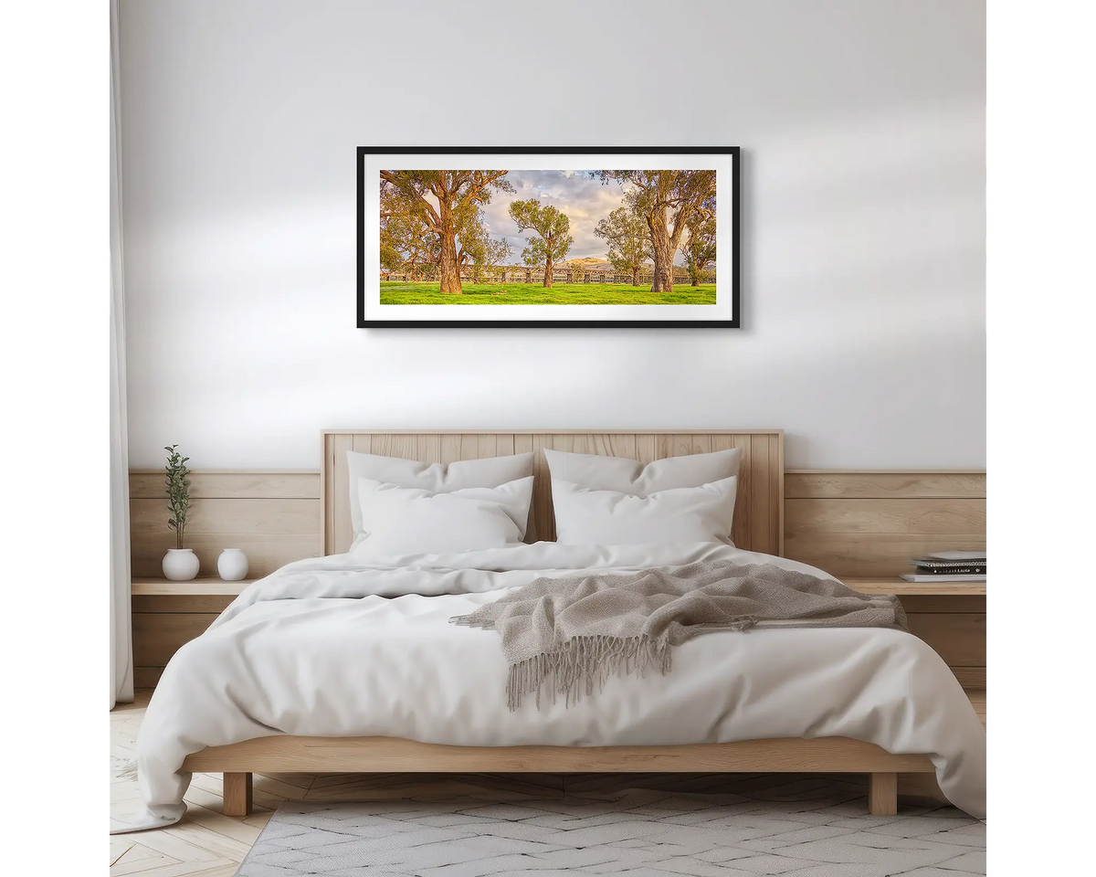 Gundagai Heritage. Country wall art print of Gundagai historic bridges, with a black frame, hung above a wooden bed. 