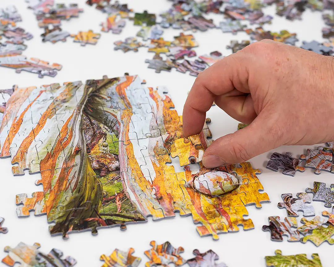 hand placing jigsaw puzzle piece.