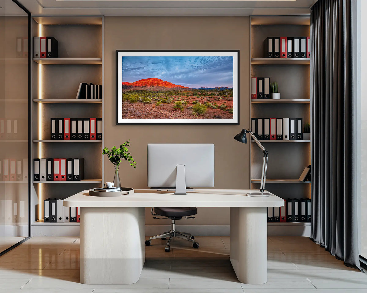 Heysen Heartland. Flinders Ranges wall art print, with a black frame, hung behind an office desk. 
