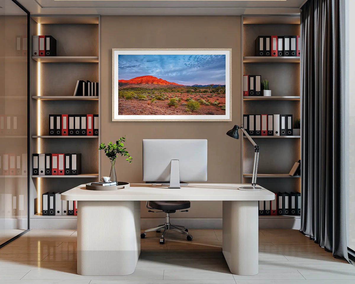Heysen Heartland. Flinders Ranges wall art print, with a Tasmanian Oak frame, hung behind an office desk. 