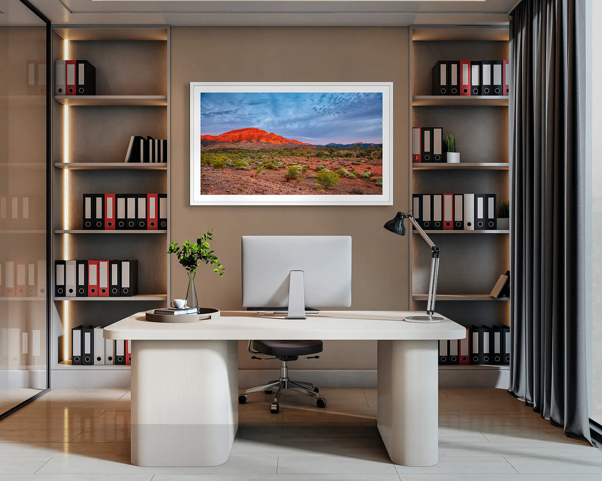 Heysen Heartland. Flinders Ranges wall art print, with a white frame, hung behind an office desk. 