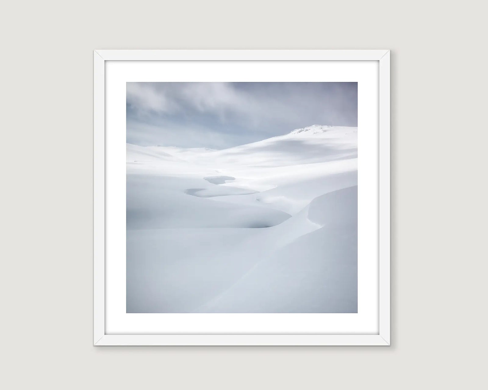 Framed wall art print of grey skies and a creek covered in heavy snow fall in Kosciuszko National Park. 