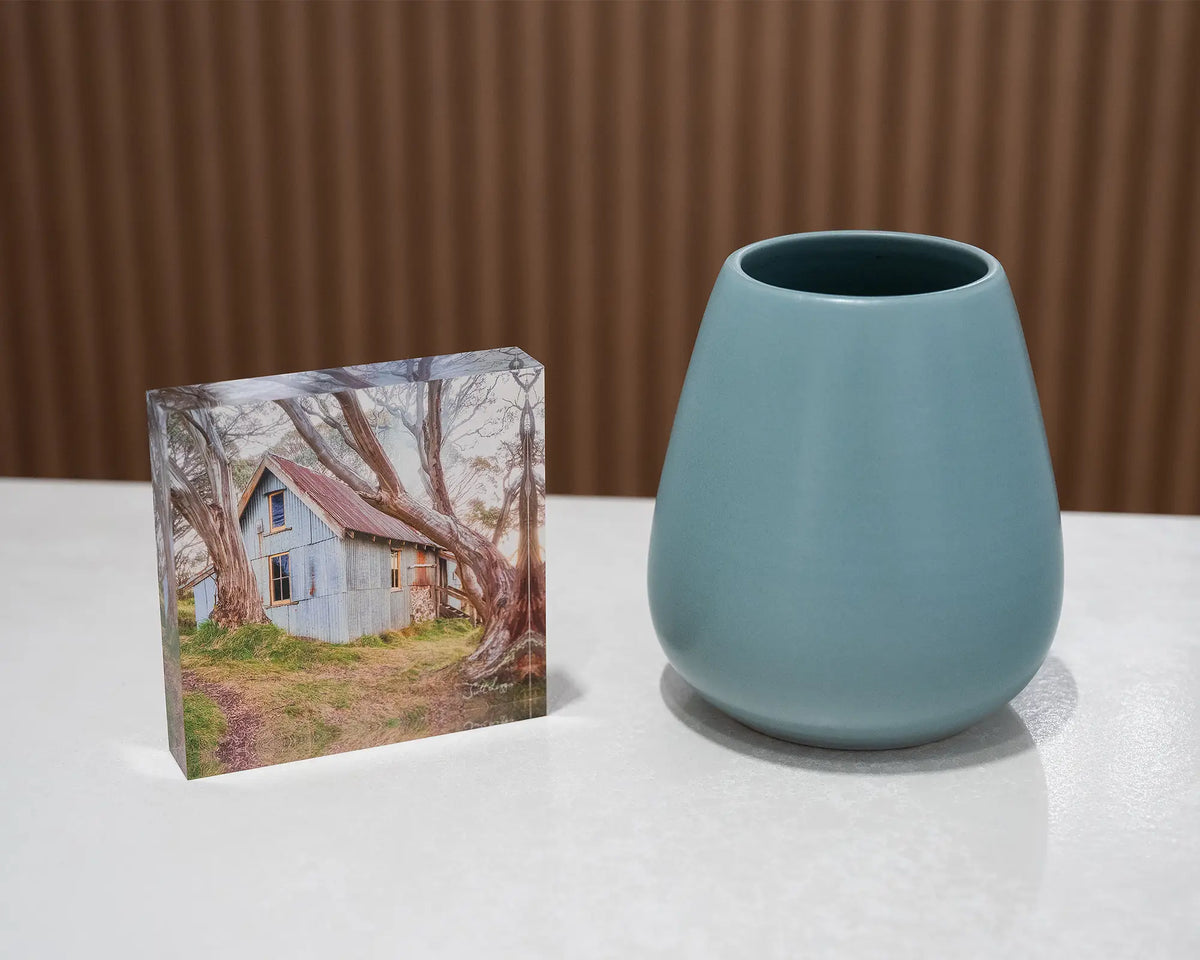 High Country Life. Acrylic block of Cope Hut, Victoria, styled with a small vase.