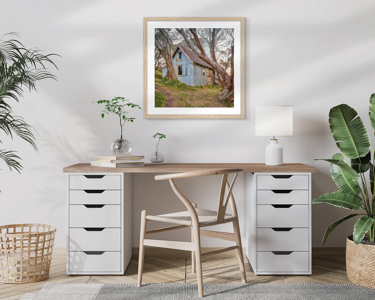 High Country Life. Cope Hut, photographic wall art print with a Tassie Oak frame, hung in a home office. 