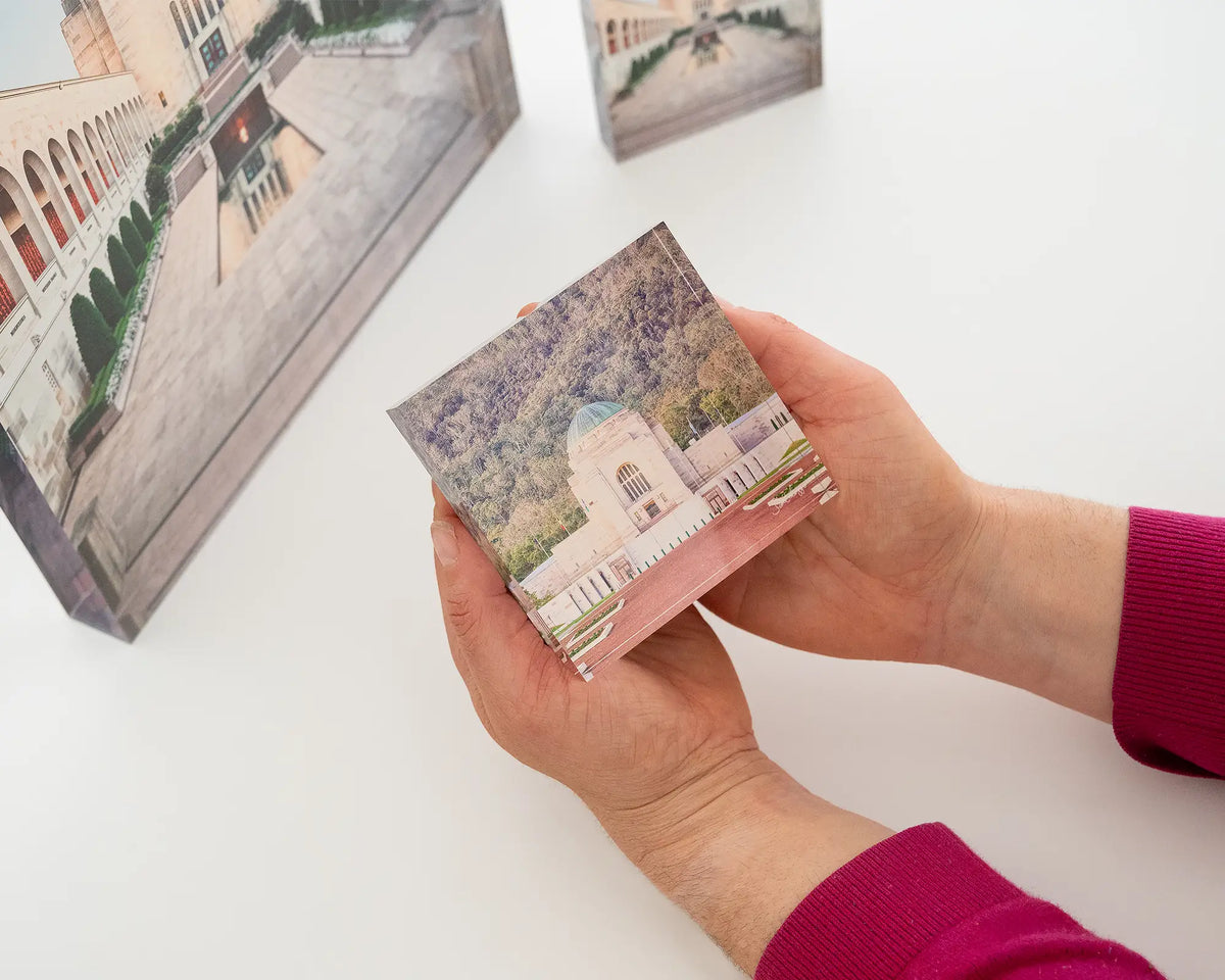 Honouring Their Spirit. Acrylic block of the Australian War Memorial, Canberra, being hand held.