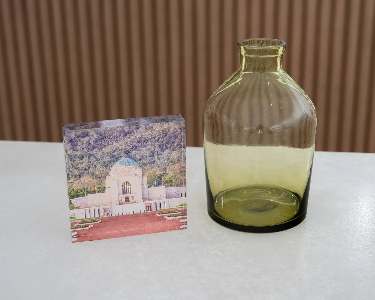 Honouring Their Spirit. Acrylic block of the Australian War Memorial, Canberra, on desk styled with a small vase.