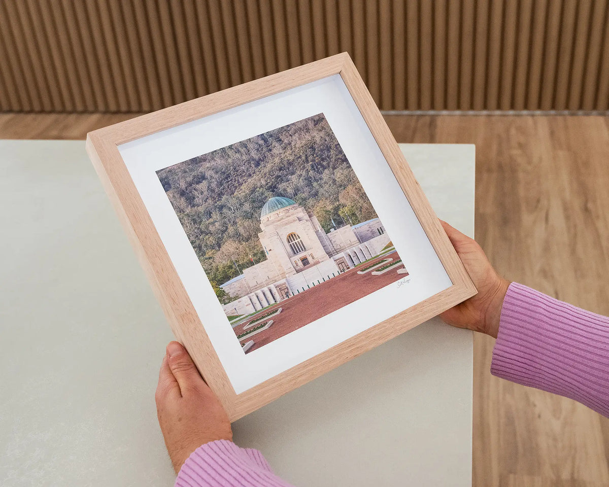 Honouring Their Spirit. Small print with timber frame of the Australian War Memorial, Canberra, held in hands.