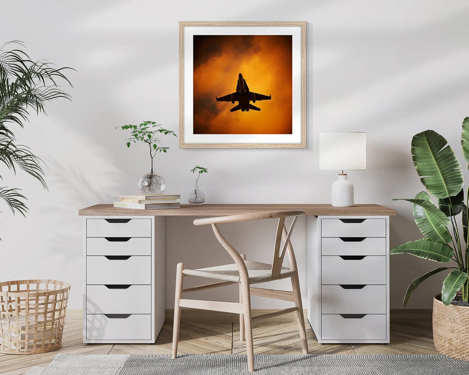 Australian Air Force F-18 Hornet against backdrop of orange clouds at sunset.