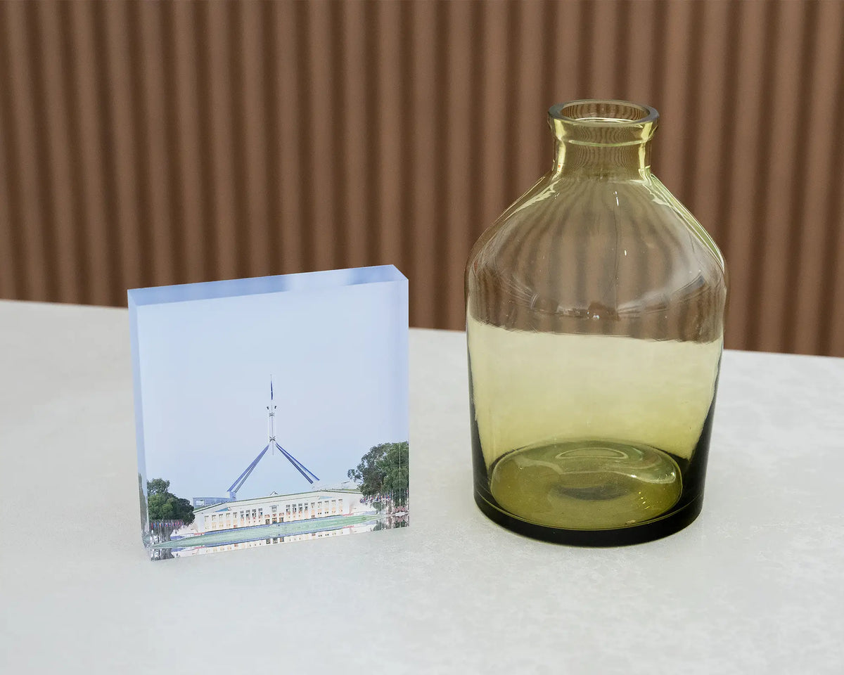 House On The Hill. Acrylic block of Parliament House, Canberra, on desk styled with a small vase.