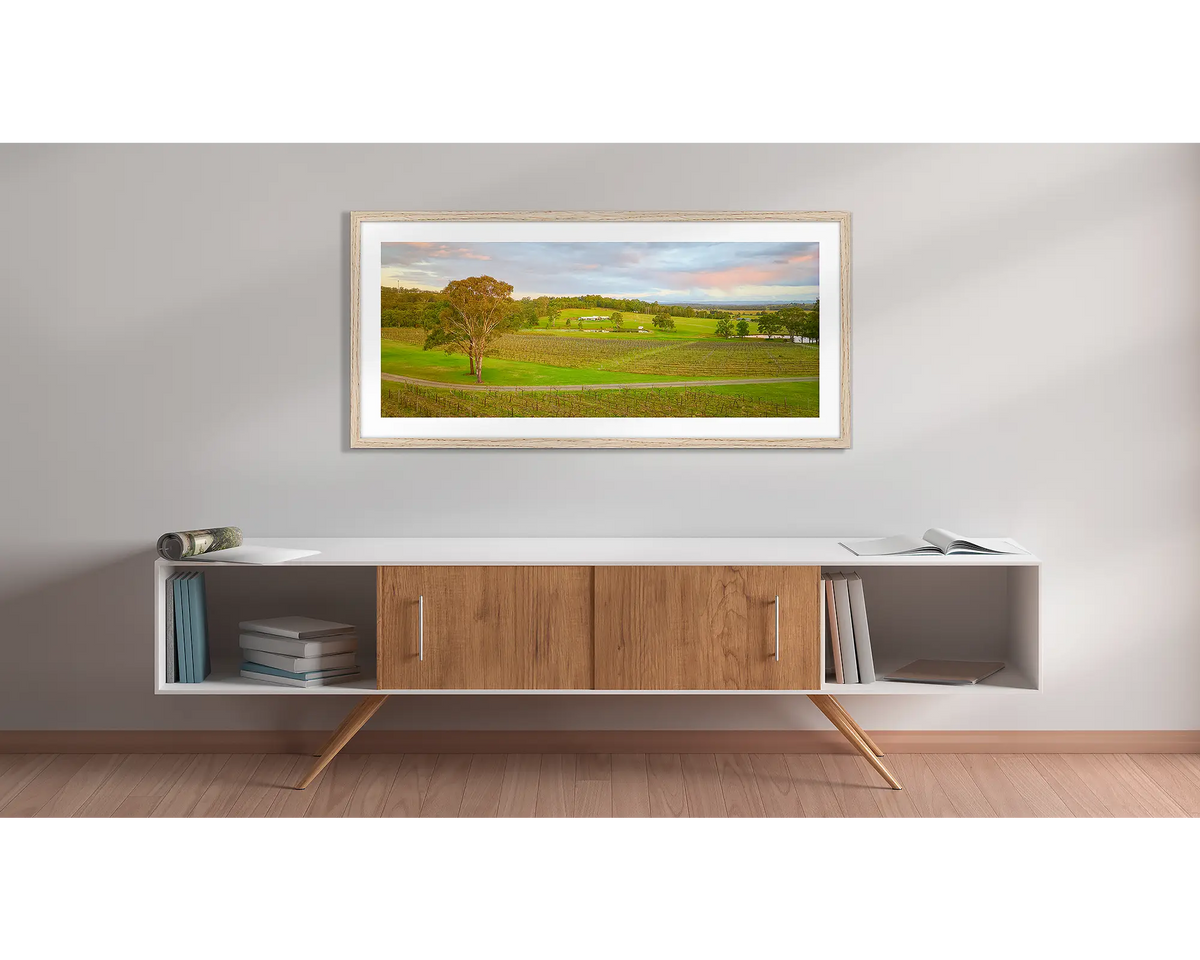 Hunter Valley Retreat. Wall art print with a timber frame, of Molly Morgan winery, hung above a side table. 
