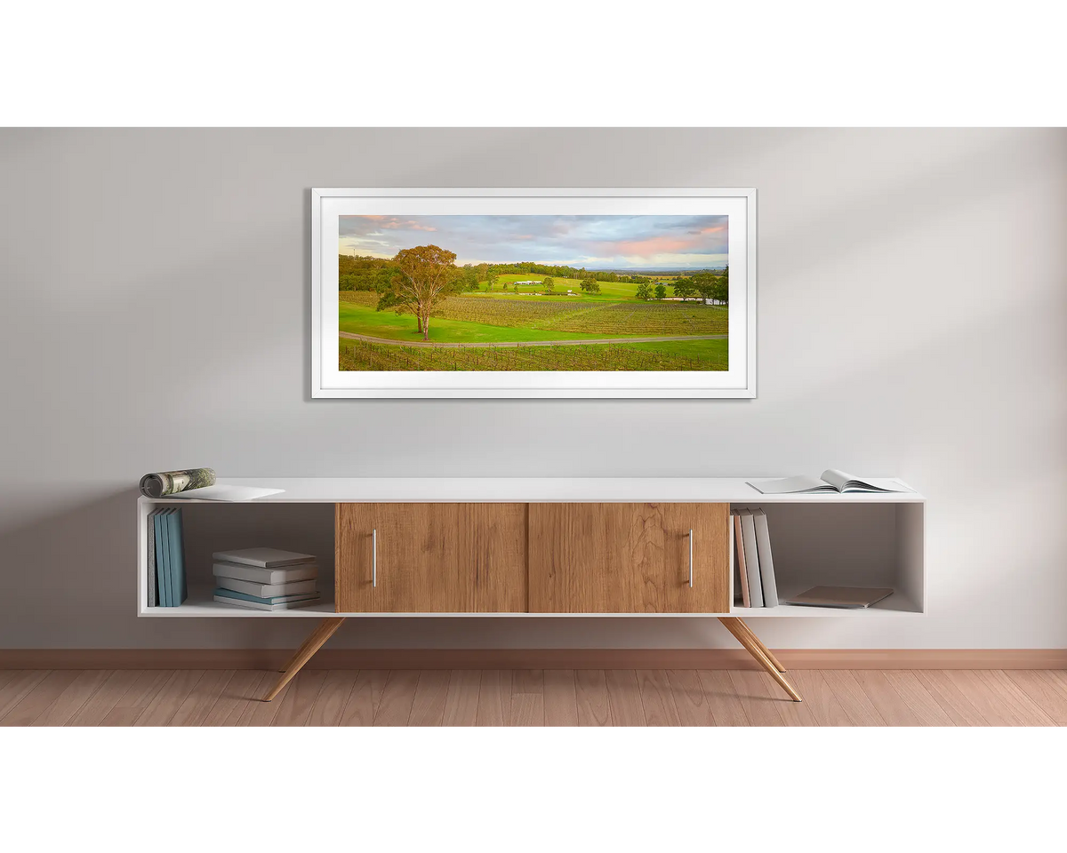 Hunter Valley Retreat. Wall art print with a white frame, of Molly Morgan winery, hung above a side table. 