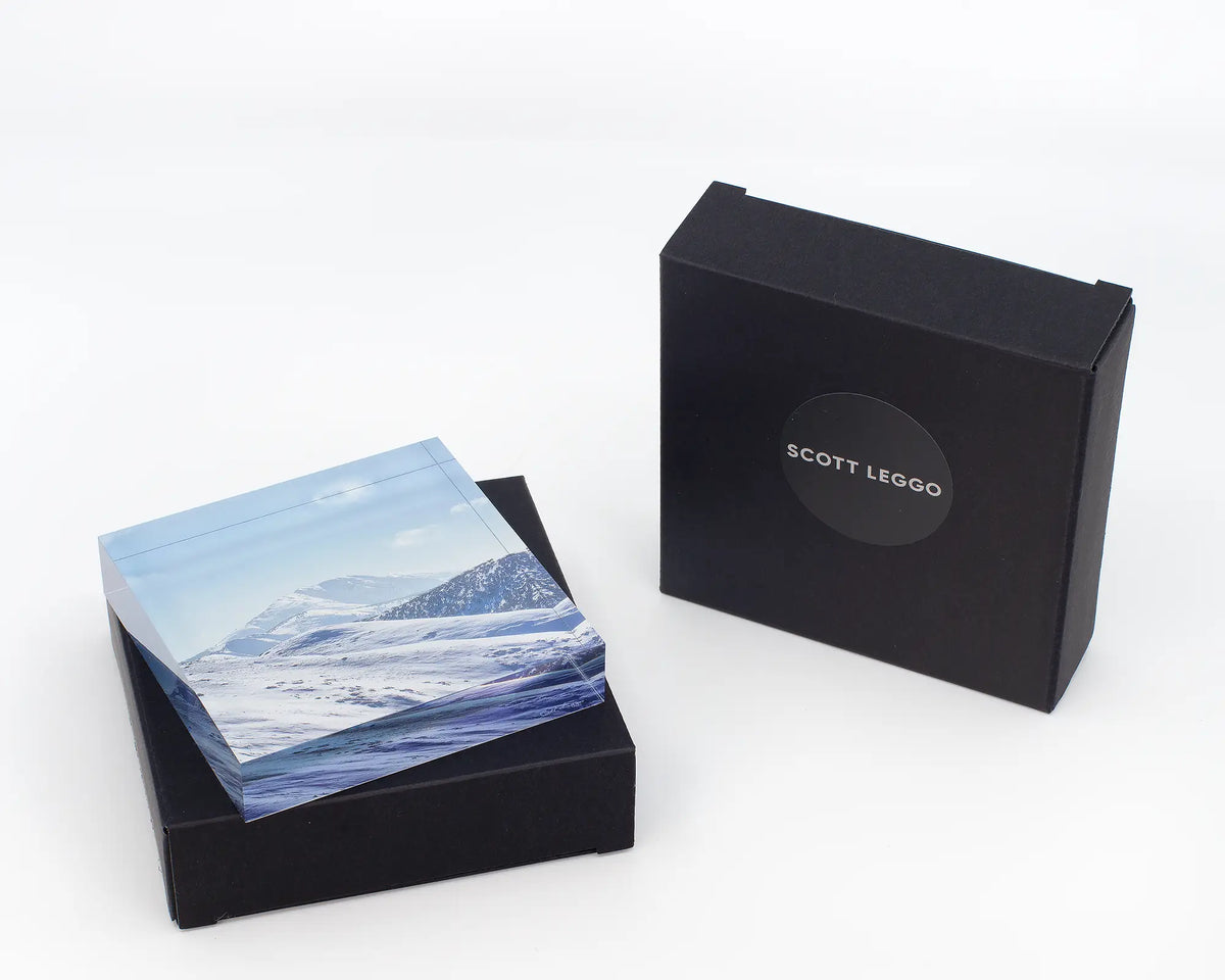 Icon of the Alps acrylic block with black gift boxes. 