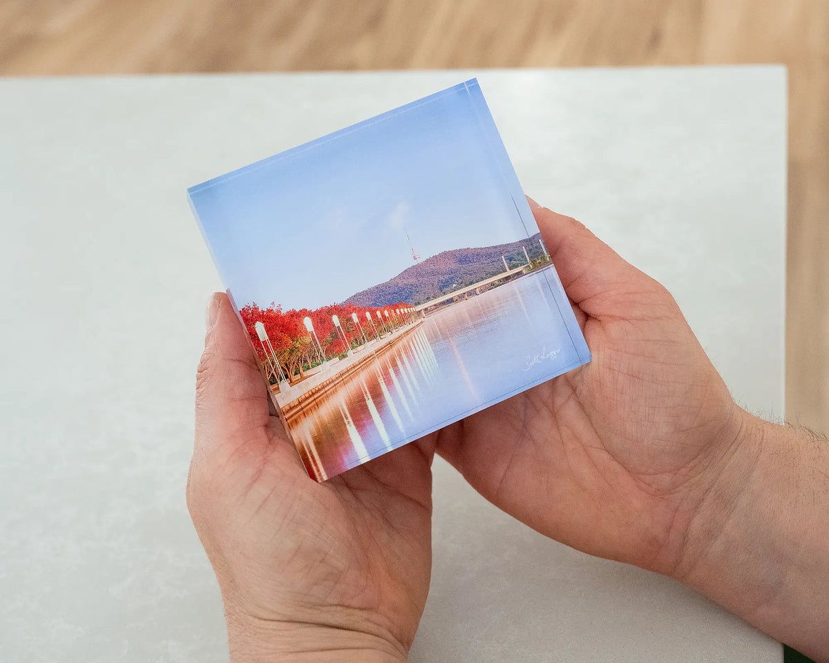 Impressions of Autumn. Acrylic block of autumn trees lining Lake Burley Griffin, Canberra, being hand held.