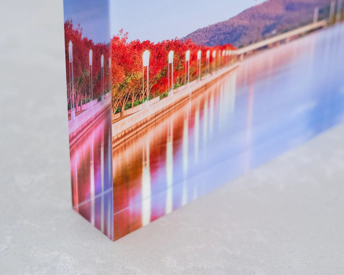 Impressions of Autumn. Acrylic block of autumn trees lining Lake Burley Griffin, Canberra, corner close-up.