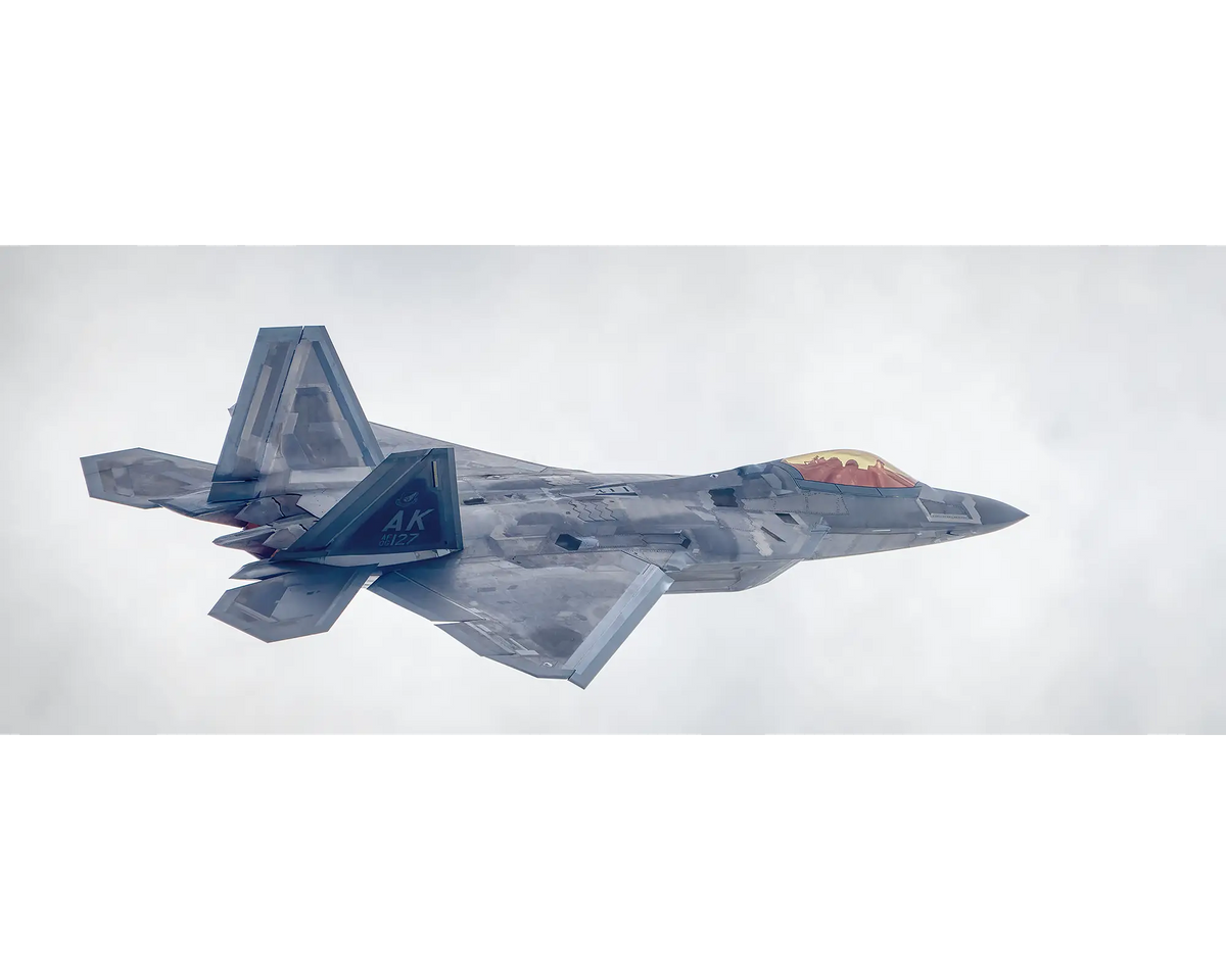 F-22 Raptor from the UNited States Air Force, flying with clouds. 