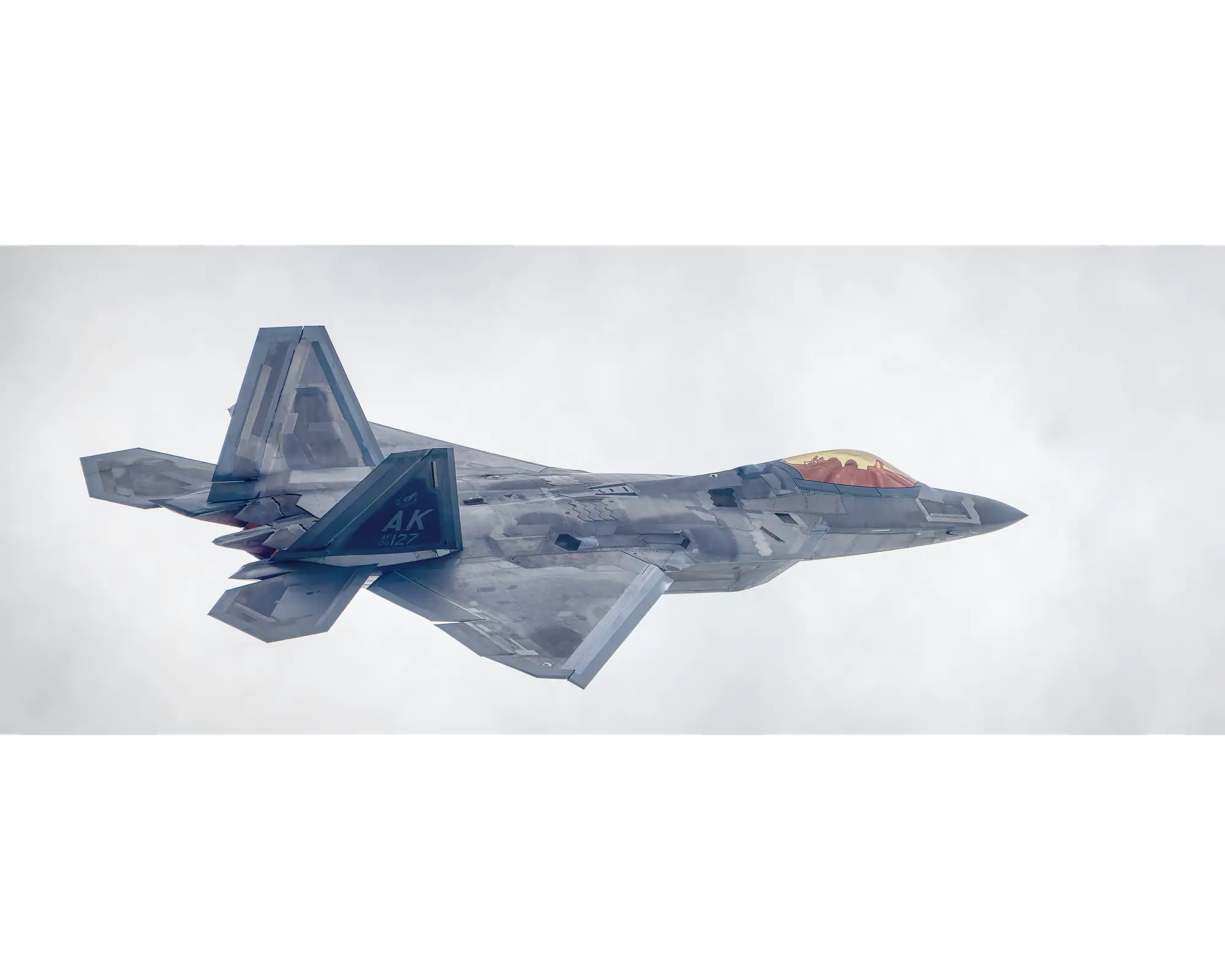 F-22 Raptor from the UNited States Air Force, flying with clouds. 